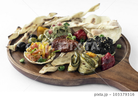 vegan tapas snacks sharing platter board on white background vegan tapas snacks sharing platter board on white background 103379316