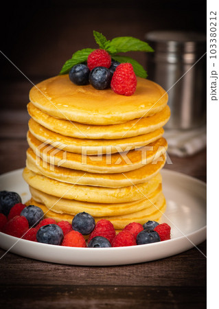 Recipe for maple syrup pancakes with raspberry and blueberry filling 103380212