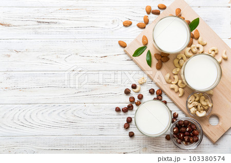Set or collection of various vegan milk almond, cashew, on table background. Vegan plant based milk and ingredients, top view Set or collection of various vegan milk almond, cashew, on table background. Vegan plant based milk and ingredients, top view 103380574