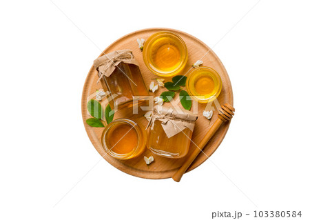 honey jar with acacia flowers and leaves isolated on white background. fresh honey top view flat lay 103380584