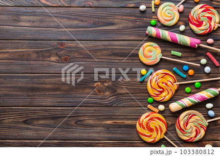 Tasty appetizing Party Accessories Happy Birthday Sweet. Different types of candies on colored background, copy space. Colorful birthday party background 103380812
