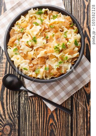 Krautfleckerl are a traditional Austrian food made out of noodles fleckerl pasta and caramelized cabbage closeup on the bowl. Vertical top view 103382128