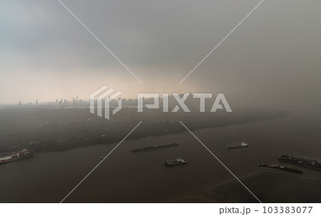 Misty Landscape of city skyscrapers covered before raining. Heavy dense smog fot during afternoon that Bangkok city cannot be seen clearly, Aerial top view of city on a foggy day. 103383077