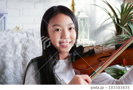 Portrait of girl playing violin at home, Kid with songs portrait 103383835