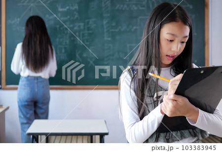 Student studying and reading textbook with happiness in classroom Student studying and reading textbook with happiness in classroom 103383945