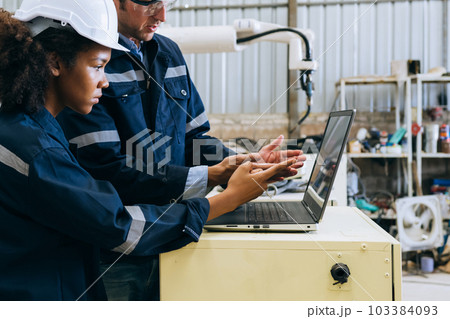 Engineer technician controlling robotic arms on computer laptop Engineer technician controlling robotic arms on computer laptop 103384093