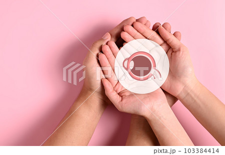 People holding virtual eye icon on hands with abstract background 103384414