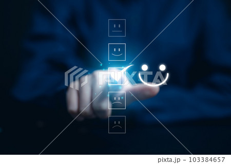 Close up of customer pressing smiley face emoticon on virtual screen Close up of customer pressing smiley face emoticon on virtual screen 103384657
