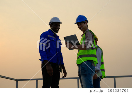 Engineers checking solar panels on solar power plant Engineers checking solar panels on solar power plant 103384705