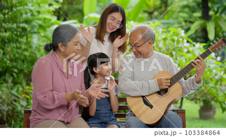 Family having activities together at home, Grandfather playing guitar happily Family having activities together at home, Grandfather playing guitar happily 103384864