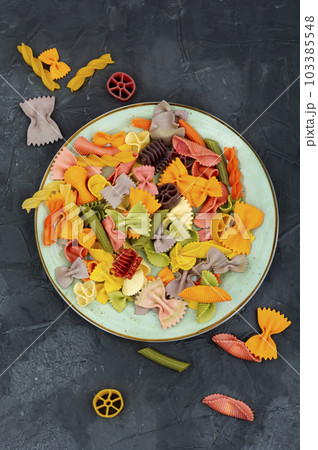 Multicolor pasta,colorful uncooked pasta. 103385548