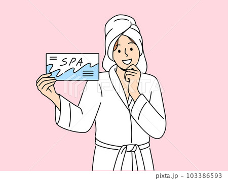 Smiling woman with spa voucher in hands  103386593