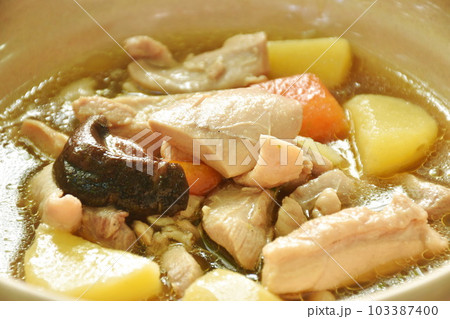 boiled chicken with potato and carrot in sweet red gravy sauce stew on bowl 103387400