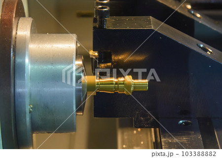 Close up scene the CNC lathe machine thread cutting at the end of brass pipe coupling parts. Close up scene the CNC lathe machine thread cutting at the end of brass pipe coupling parts. 103388882