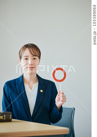 まるの判定をする若い女性弁護士 103389068