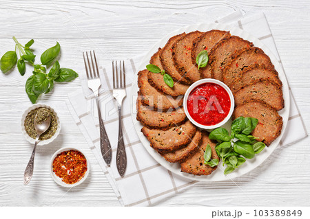 italian meatloaf cut in slices on white plate 103389849