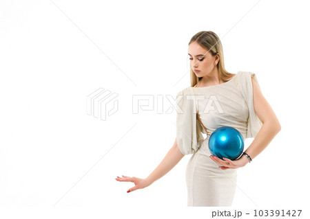 Gymnast dressed in evening dress with ball on white background Gymnast dressed in evening dress with ball on white background 103391427