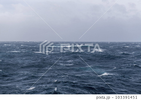 Beautiful seascape - waves and sky with clouds with beautiful lighting. Stormy sea, Bad weather. Gale. Rough sea. Beautiful seascape - waves and sky with clouds with beautiful lighting. Stormy sea, Bad weather. Gale. Rough sea. 103391451