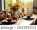 Seasonal table setting with pumpkins and flowers Seasonal table setting with pumpkins and flowers 103393313