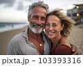 Middle age cuddling couple enjoying time on beach Middle age cuddling couple enjoying time on beach 103393316