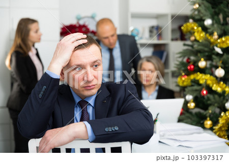 Business team tensely solving problems in office with offended man foreground 103397317