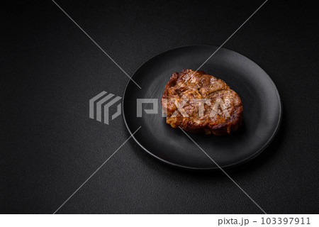 Delicious juicy pork or beef steak grilled with salt, spices and herbs 103397911