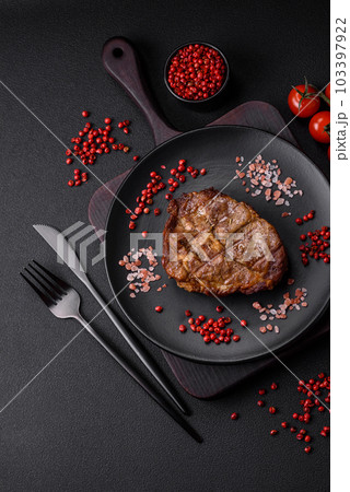 Delicious juicy pork or beef steak grilled with salt, spices and herbs Delicious juicy pork or beef steak grilled with salt, spices and herbs 103397922