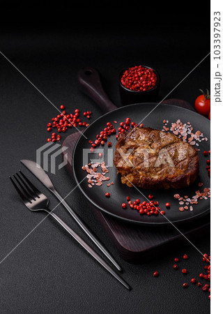 Delicious juicy pork or beef steak grilled with salt, spices and herbs Delicious juicy pork or beef steak grilled with salt, spices and herbs 103397923