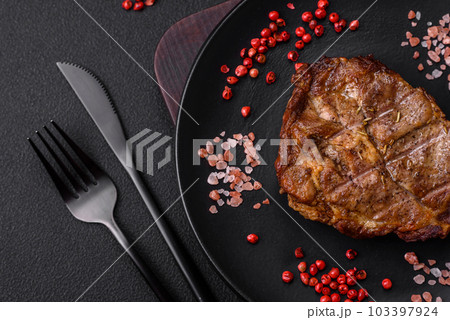 Delicious juicy pork or beef steak grilled with salt, spices and herbs Delicious juicy pork or beef steak grilled with salt, spices and herbs 103397924