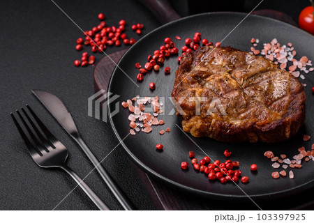 Delicious juicy pork or beef steak grilled with salt, spices and herbs Delicious juicy pork or beef steak grilled with salt, spices and herbs 103397925