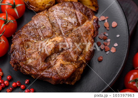 Delicious juicy pork or beef steak grilled with salt, spices and herbs Delicious juicy pork or beef steak grilled with salt, spices and herbs 103397963