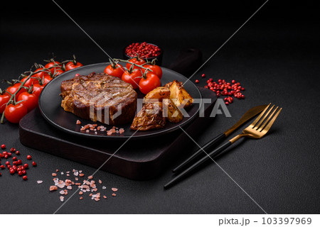 Delicious juicy pork or beef steak grilled with salt, spices and herbs 103397969