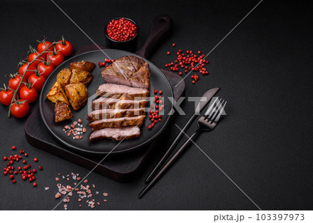 Delicious juicy pork or beef steak grilled with salt, spices and herbs Delicious juicy pork or beef steak grilled with salt, spices and herbs 103397973