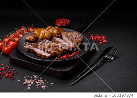 Delicious juicy pork or beef steak grilled with salt, spices and herbs Delicious juicy pork or beef steak grilled with salt, spices and herbs 103397974