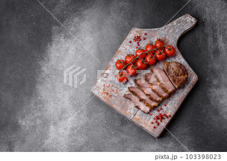Delicious juicy pork or beef steak grilled with salt, spices and herbs 103398023