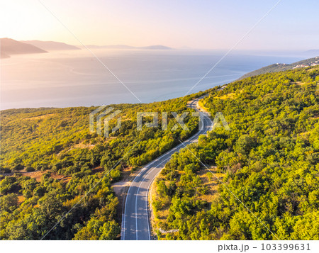 Winding coastal road, rocky cliffs and blue sea in sunny morning. Istria, Croatia 103399631