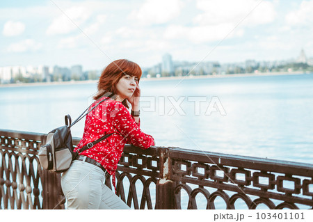 the girl on the embankment is standing with her back the girl on the embankment is standing with her back 103401101