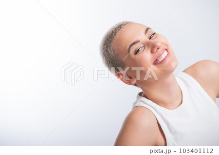 Beautiful young caucasian woman with a short haircut on a white background. 103401112