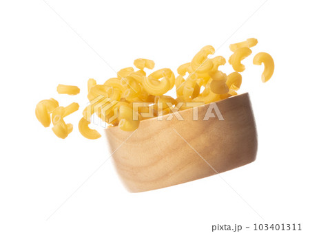 Macaroni fall on wooden bowl, yellow macaronis pasta float explode, abstract cloud fly. Curved macaroni pasta splash throwing in Air. White background Isolated high speed shutter, freeze motion Macaroni fall on wooden bowl, yellow macaronis pasta float explode, abstract cloud fly. Curved macaroni pasta splash throwing in Air. White background Isolated high speed shutter, freeze motion 103401311