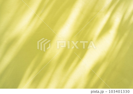 Natural shadow overlay on yellow colored grunge wall concrete texture background. 103401330