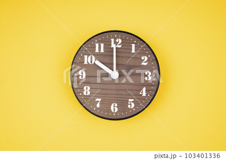 The Retro wooden clock at 10 O' clock on yellow color background. The Retro wooden clock at 10 O' clock on yellow color background. 103401336