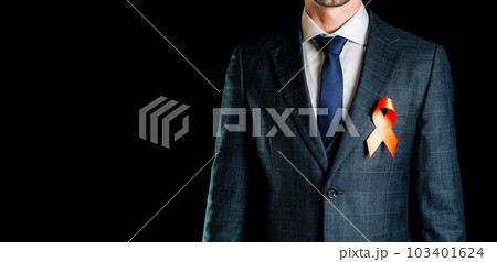 Hiv ribbon. Red ribbon in hiv world day in man hand. Awareness aids and cancer symbol on black background. HIV, AIDS and aging awareness month with copy space. 103401624