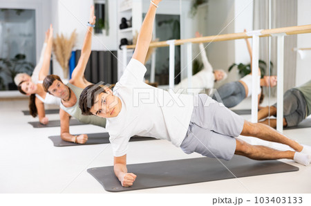 Young boy doing pilates in gym Young boy doing pilates in gym 103403133