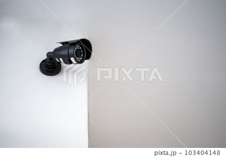 CCTV cameras installed on a white wall. Concept of surveillance and monitoring. 103404148