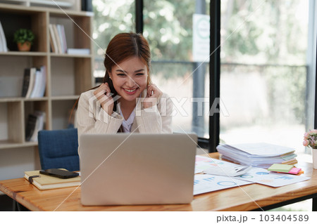 Asian Business person makes analysis and research financial report at office, analyzes profits. Accountant checks status of financial 103404589