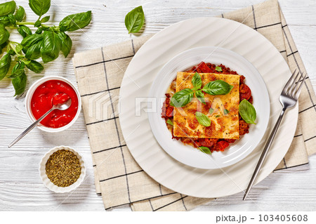 portion of upside down pizza on white plate 103405608