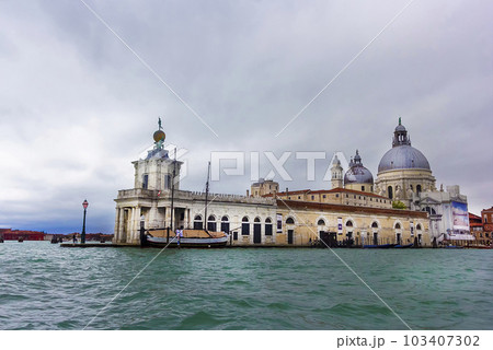 Canal in Venice from Punta della Dogana and the domes of Santa Maria della Salute. May 2023 Canal in Venice from Punta della Dogana and the domes of Santa Maria della Salute. May 2023 103407302