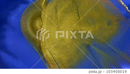 Golden waves flow over blue paint abstract background. Slow motion. Golden yellow ink splash flowing over bright blue liquid surface. Rich deep color texture. Acrylic fluid art. Shiny artwork backdrop Golden waves flow over blue paint abstract background. Slow motion. Golden yellow ink splash flowing over bright blue liquid surface. Rich deep color texture. Acrylic fluid art. Shiny artwork backdrop 103408019