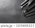 Auto mechanic's tools on grey stone table with copy space	 103409321