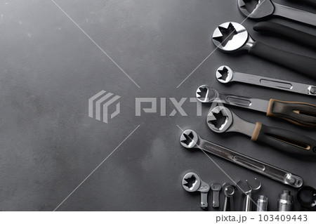 Auto mechanic's tools on grey stone table with copy space Auto mechanic's tools on grey stone table with copy space 103409443
